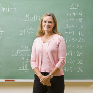 Teacher standing near blackboard