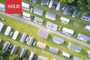 Caravan site park aerial view illuminated by summer sun