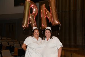 RNS CELEBRATING: From left, Ashley Andel of Salisbury and Kristy Davis of Crisfield celebrate becoming registered nurses with balloons at the Wor-Wic Community College nursing awards and recognition ceremony.