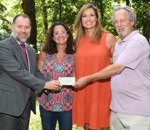 two men and two women holding the terrill scholarship donation