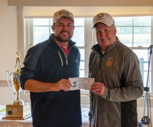 two golfers holding gift certificate