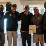 group of golfers holding gift certificate
