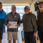 group of golfers holding certificate