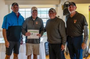 group of golfers holding certificate