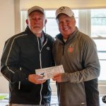 two golfers holding gift certificate
