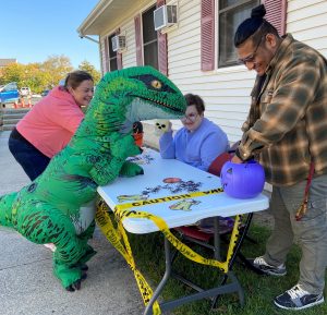 T-Rex costume at a sign up table