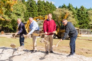 Four men breaking ground with shovels