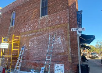 Ghost Sign Being Restored in Snow Hill – Just in Time for Halloween!