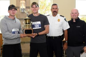 four police offers standing with 5k trophy