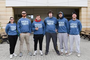 group of people wearing physical therapist sweatshirts outside
