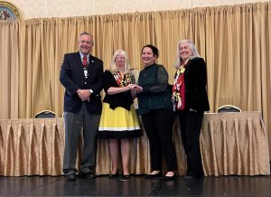 group of people on staging receiving award