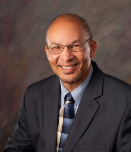 headshot of male wearing suit