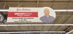 Grocery store sign with picture of a man on it