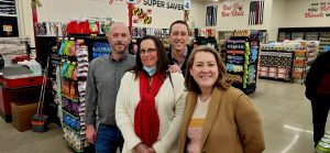 Group of four people in a grocery store