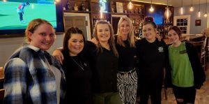 group of female staff standing at bar