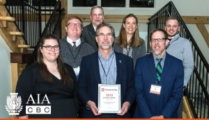 team standing on stairs holding award