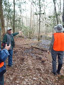 volunteers standing in woods