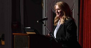 woman speaking at podium