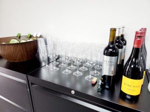 Table set with wine glases, bottles of wine and an ice bucket