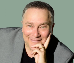 headshot of male wearing suit smiling