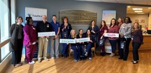 hospital staff with parents holding newborn