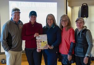 group of people standing together at golf event