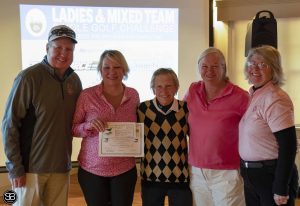 group of people holding award at golf event