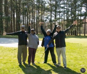 4 people standing on golf course