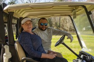 two golfers sitting in golf cart