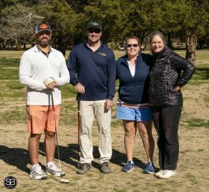 4 golfers standing on golf course
