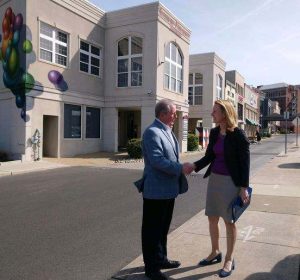 Comptroller Brooke Lierman shaking hands with gentleman outside