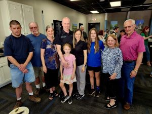 family standing together inside physical therapy center