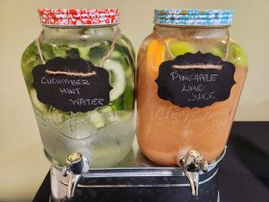 two glass jars filled with flavored water and juice