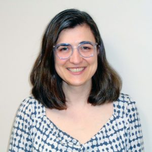 headshot of woman wearing glasses smiling