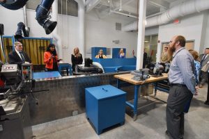 group of people standing in college technology center