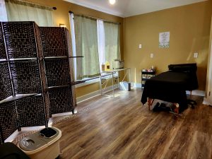 room with massage table and screen