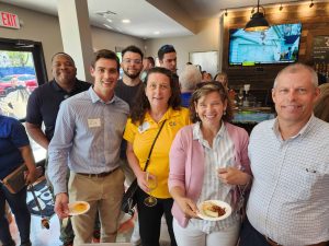 people at event holding food and drinks