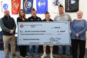 group of veterans holding donation check