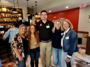 group standing together in Taylor's BBQ bar