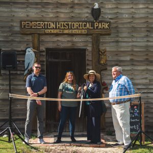 four people standing outside nature center at ribbon cutting