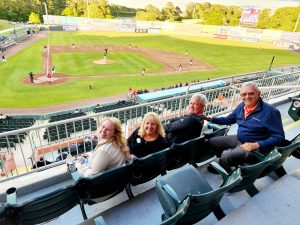 four people sitting outside at shorebirds stadium