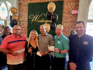 Door prize winners L-R Rob Fuller, Chris Phillips, Corey Boerner and David Engelhardt with Holly Worthington