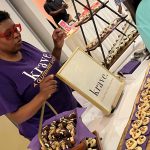 lady standing at krave table at event with desserts