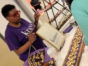 lady standing at krave table at event with desserts