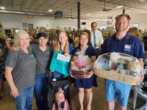 Marlene Bohn and Silvia Ochoa with door prize winners L-R Kayla Harrison Melissa Geeslin and Corey Boerner Baby Maggie sitting in stroller