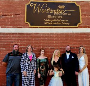 Worthington Realty Group, L-R, Josh Rose, Daisy Rose, Alana Coffey, Holly Worthington (with daughter Camelia), Colin Eck and Stacie Walsh