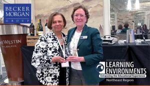 two staff members of Becker Morgan Group holding award