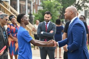 governor moore shaking hands with baltimore resident