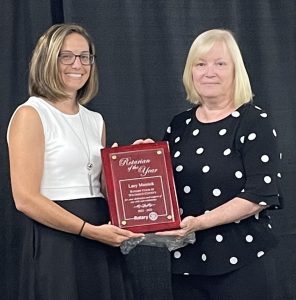 two ladies holding award