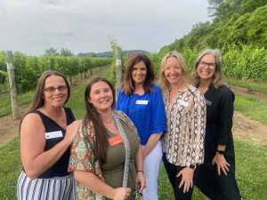group of ladies standing outside at vineyard event
